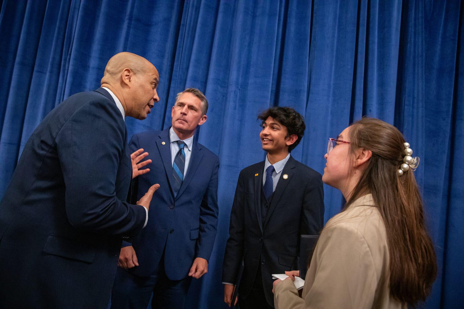 Group discussion with man gesturing earnestly.